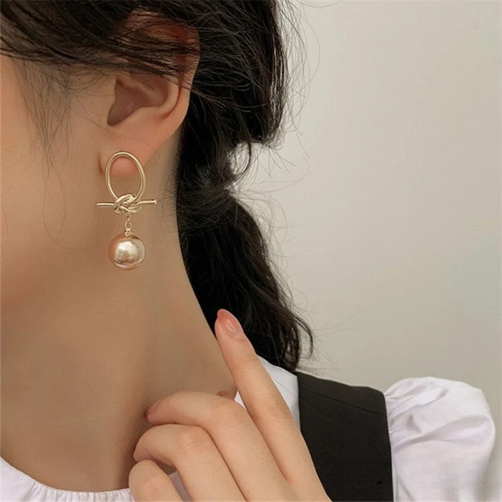 Boucles d'oreilles créoles avec perles dorées