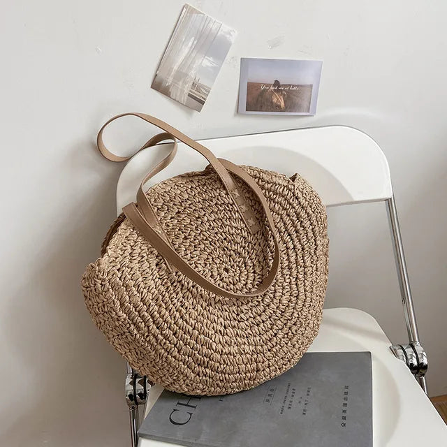 Arnora | Sac rond tressé avec poignées en simili cuir