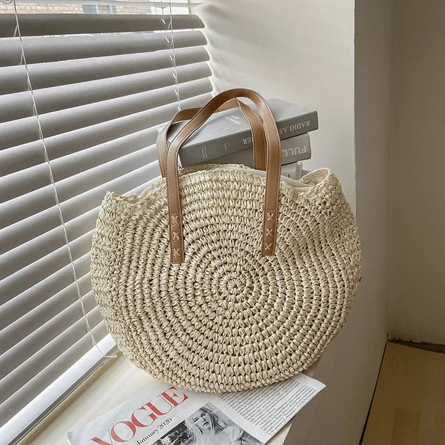 Arnora | Sac rond tressé avec poignées en simili cuir