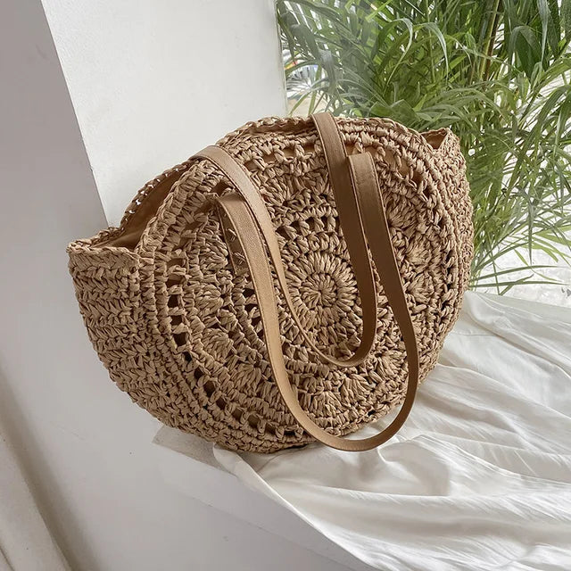 Arnora | Sac rond tressé avec poignées en simili cuir
