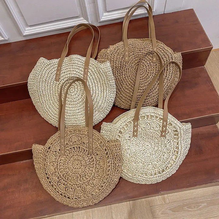 Arnora | Sac rond tressé avec poignées en simili cuir